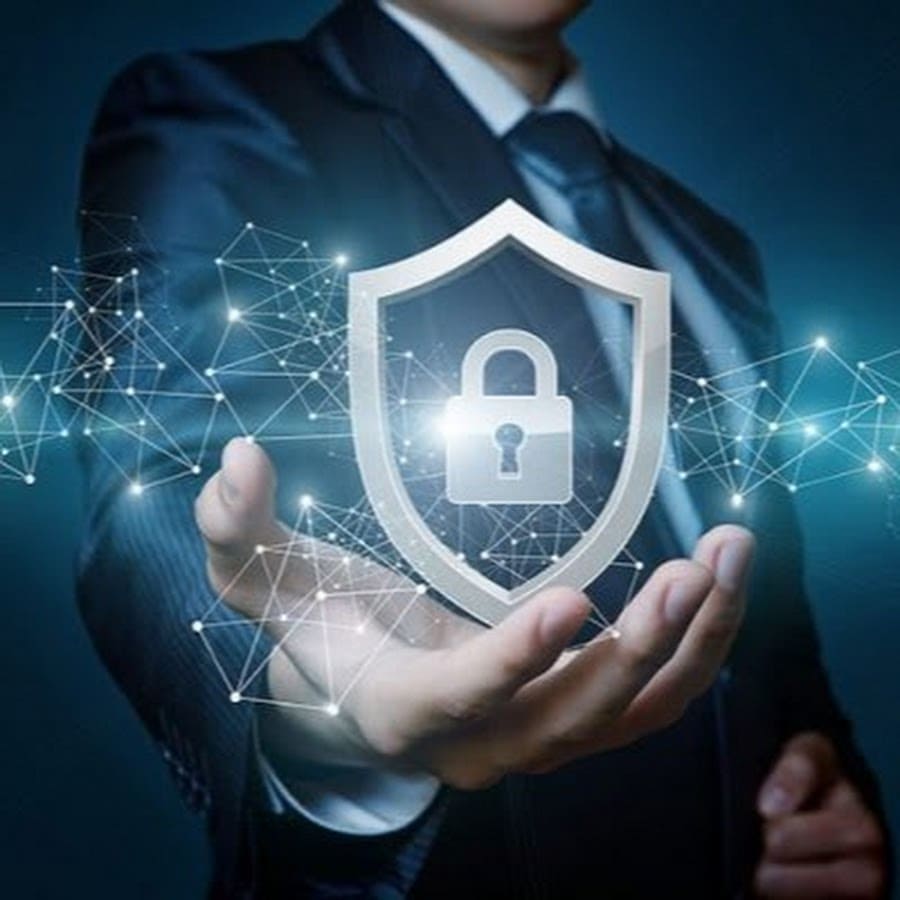 Businessman holding a shield with a padlock, symbolizing robust cybersecurity protection